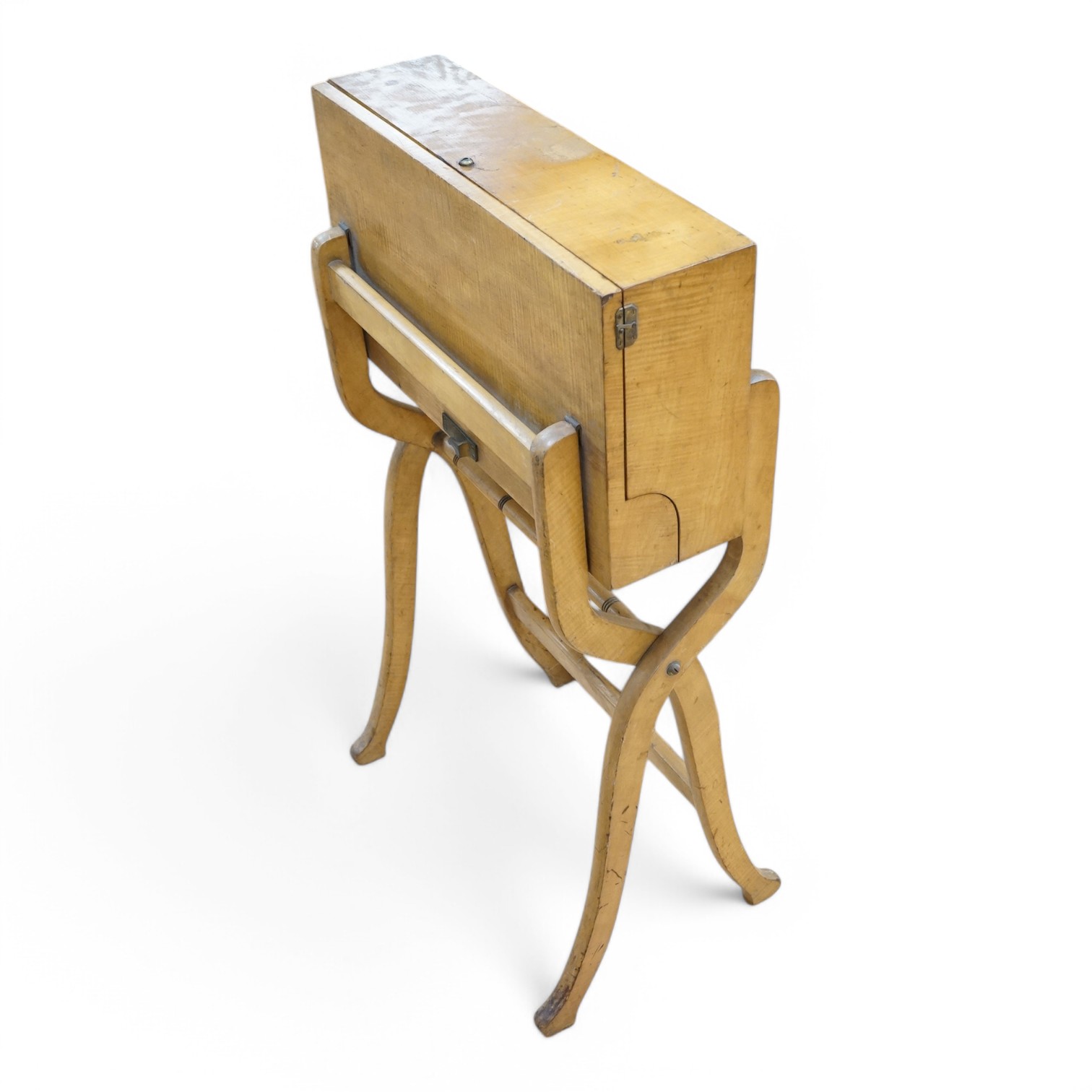 A late 19th century sycamore military folding campaign desk, raised on a trestle stand with X shaped supports, desk section with leather writing surface and folding letter rack, 93cm high, 56cm wide when folded. Conditio